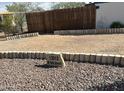 Charming home address marker nestled in rock landscaping with a rustic wooden fence at 13013 N 18Th St, Phoenix, AZ 85022