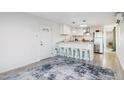 Modern kitchen featuring white cabinets, stainless steel appliances, and a breakfast bar with seating at 13013 N 18Th St, Phoenix, AZ 85022