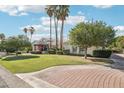Lush lawn with mature trees and landscaping, including a brick driveway that leads to the house at 1330 N 40Th St # 1, Mesa, AZ 85205