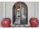Ornate arched front door with large glass panes and black iron designs opens to the entry way at 1330 N 40Th St # 1, Mesa, AZ 85205