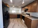 Well-lit kitchen featuring light countertops, wood cabinets, and modern appliances at 1354 S 228Th Dr, Buckeye, AZ 85326
