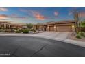 Beautiful single story home at dusk with desert landscaping, warm lighting, and an inviting driveway at 14708 E Canyoncrest Ct, Fountain Hills, AZ 85268