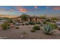 Expansive front yard featuring desert landscaping with mature plants, trees, and a two-car garage at 14708 E Canyoncrest Ct, Fountain Hills, AZ 85268