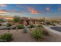 Desert landscaping with mature plants, trees, and a view of the two-car garage at 14708 E Canyoncrest Ct, Fountain Hills, AZ 85268
