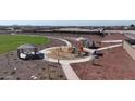 Aerial view of a neighborhood playground featuring play structures and picnic areas at 17539 W Victory St, Goodyear, AZ 85338