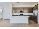 Modern kitchen with stainless steel appliances, a spacious island, and ample cabinetry for storage and functionality at 17545 W Victory St, Goodyear, AZ 85338