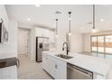 Modern kitchen with white cabinets, stainless appliances, island and pendant lights at 18759 E Panchito Dr, Gold Canyon, AZ 85118