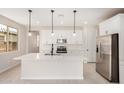 Bright modern kitchen featuring white cabinets, stainless appliances, and an island at 18759 E Panchito Dr, Gold Canyon, AZ 85118