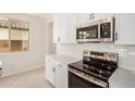 Modern kitchen with white cabinets, stainless steel microwave and oven at 18759 E Panchito Dr, Gold Canyon, AZ 85118