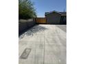 Spacious driveway with a wooden gate adding privacy to the home at 1915 W Missouri Ave, Phoenix, AZ 85015