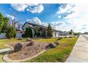 Expansive front yard with mature trees, rock landscaping, and circular garden bed at 2149 E Hermosa Vista Dr, Mesa, AZ 85213