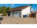 View of the three-car garage with stone accents and extra-long driveway at 2149 E Hermosa Vista Dr, Mesa, AZ 85213