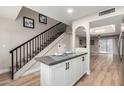 Modern kitchen featuring stainless steel appliances, gray countertops, and a breakfast bar leading to a staircase and living room at 220 N 22Nd Pl # 1022, Mesa, AZ 85213
