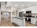 Bright kitchen with stainless steel appliances, a breakfast bar, and seamless flow into the inviting living room at 220 N 22Nd Pl # 1022, Mesa, AZ 85213