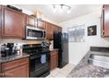 Functional kitchen with modern appliances, black refrigerator, and granite countertops, ideal for cooking at 2301 E University Dr # 341, Mesa, AZ 85213