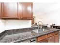 Granite countertop in kitchen, seamlessly connecting the kitchen to living area and a stainless sink at 2301 E University Dr # 341, Mesa, AZ 85213