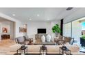 Bright living room featuring stylish furniture, a modern TV, and large windows bringing in natural light at 26355 N 79Th Dr, Peoria, AZ 85383