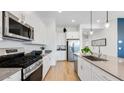 Modern kitchen featuring stainless steel appliances, white cabinets, and a spacious layout at 26391 N 79Th Dr, Peoria, AZ 85383