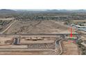 An aerial view of new construction in the desert with a winding road, houses, and vast desert landscape at 2823 N Arroyo Grande Ave, Casa Grande, AZ 85122