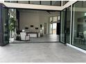 Bright living room featuring high ceilings, tile flooring, and bi-fold doors to the outside at 3502 S Kings Ranch Rd, Gold Canyon, AZ 85118