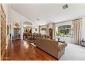 Bright living room with hardwood floors, large windows, and elegant furnishings at 3750 E Palm St, Mesa, AZ 85215