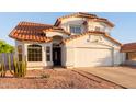 Charming two-story home featuring a terracotta tile roof, neutral stucco, and a well-maintained front yard at 4049 E Arbor Ave, Mesa, AZ 85206