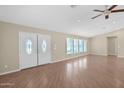 Spacious living room with new flooring, recessed lighting, ceiling fan, and double-door entry at 4112 N 4Th Ave, Phoenix, AZ 85013