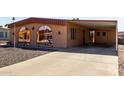 Cozy home featuring covered parking, gravel yard, and brick accents at 5221 E Mills Ct, Mesa, AZ 85215