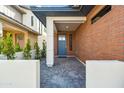 Inviting front porch with brick accents and a stylish blue front door at 5533 E Earll Dr, Phoenix, AZ 85018