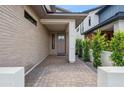Covered entryway with modern brickwork, neutral colors, and desert landscaping at 5537 E Earll Dr, Phoenix, AZ 85018
