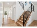 Bright entryway featuring modern wooden staircase with sleek black metal railing at 5537 E Earll Dr, Phoenix, AZ 85018