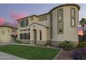 Attractive home exterior with a manicured lawn and unique architectural details at 5628 N Rattler Way, Litchfield Park, AZ 85340