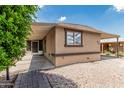 A tan single-story home featuring a covered parking and minimal desert landscaping at 6812 N Polk St # 223, Phoenix, AZ 85043