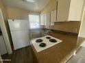 Cozy kitchen with essential appliances, ample counter space, and a window that provides natural light at 6832 W Vogel Ave, Peoria, AZ 85345