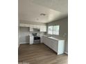 Bright kitchen featuring modern stainless steel appliances and white cabinetry at 7007 S 45Th Pl, Phoenix, AZ 85042