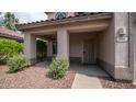 Covered porch with desert landscaping, including small bushes, rocks, and a sidewalk leading to the front door at 726 E Rose Marie Ln, Phoenix, AZ 85022