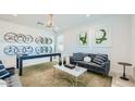 Cozy living room featuring stylish decor, comfortable seating, and ample natural light at 7842 W Tether Trl, Peoria, AZ 85383