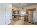 Functional kitchen boasts stainless steel appliances, granite countertops, and ample cabinet space at 7937 W Chickasaw St, Phoenix, AZ 85043