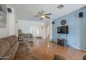 Inviting living room features wood floors, neutral walls, and large windows for ample natural light at 7937 W Chickasaw St, Phoenix, AZ 85043