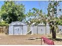 Exterior shot of two metal utility sheds in the back yard providing additional storage space and project potential at 8502 N 26Th Ave, Phoenix, AZ 85021
