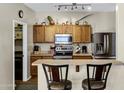 Kitchen featuring dark appliances, light counter tops and convenient bar seating at 110 E Saddle Way, San Tan Valley, AZ 85143