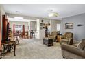 Cozy living room with carpet, ceiling fan, and views into the dining and kitchen areas at 110 E Saddle Way, San Tan Valley, AZ 85143