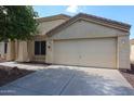Attached two-car garage with a concrete driveway and manicured desert landscaping at 11746 W Camino Vivaz --, Sun City, AZ 85373