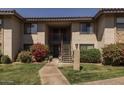 Inviting two-story condo with well-maintained landscaping and stair access to upper units at 1402 E Guadalupe Rd # 215, Tempe, AZ 85283