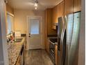 Galley kitchen with stainless steel appliances, granite counters and bright natural light at 1718 E Gaylon Dr, Tempe, AZ 85282