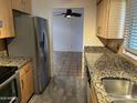 Galley kitchen with stainless steel appliances and decorative granite countertops at 1718 E Gaylon Dr, Tempe, AZ 85282