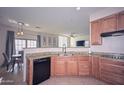Charming kitchen featuring granite countertops, wood cabinets, and an open floorplan at 1851 W Vermont Ave, Phoenix, AZ 85015