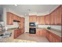 A kitchen with wood cabinets, granite countertops, and black appliances provides style and functionality at 1851 W Vermont Ave, Phoenix, AZ 85015