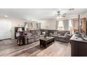 Comfortable living room featuring cozy couches, a ceiling fan and laminate floors at 18525 W Valerie Dr, Surprise, AZ 85374