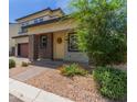 Charming two-story home featuring a landscaped front yard and covered porch at 1857 W 22Nd Ave, Apache Junction, AZ 85120